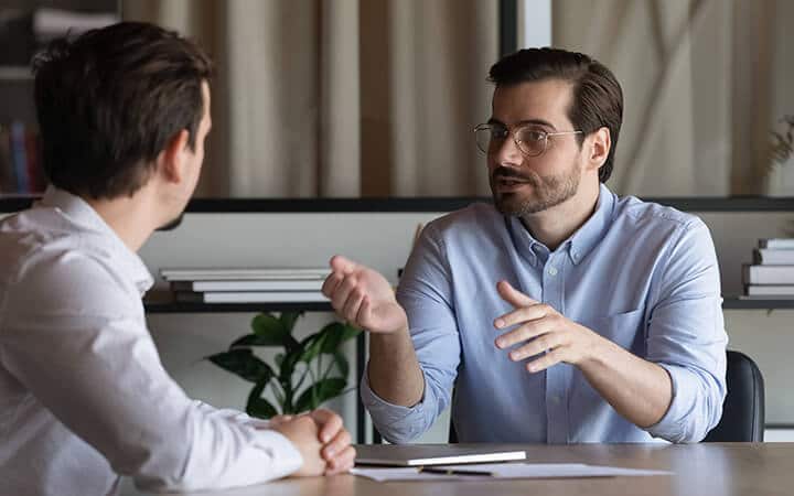 Young guy taking advice from a mentor