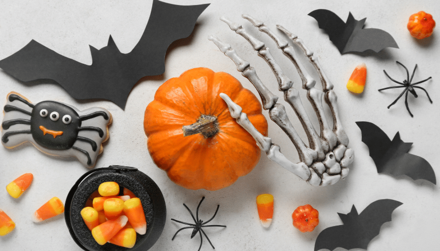 Skeletons, bats, pumpkins, and candy are arranged on a white background.